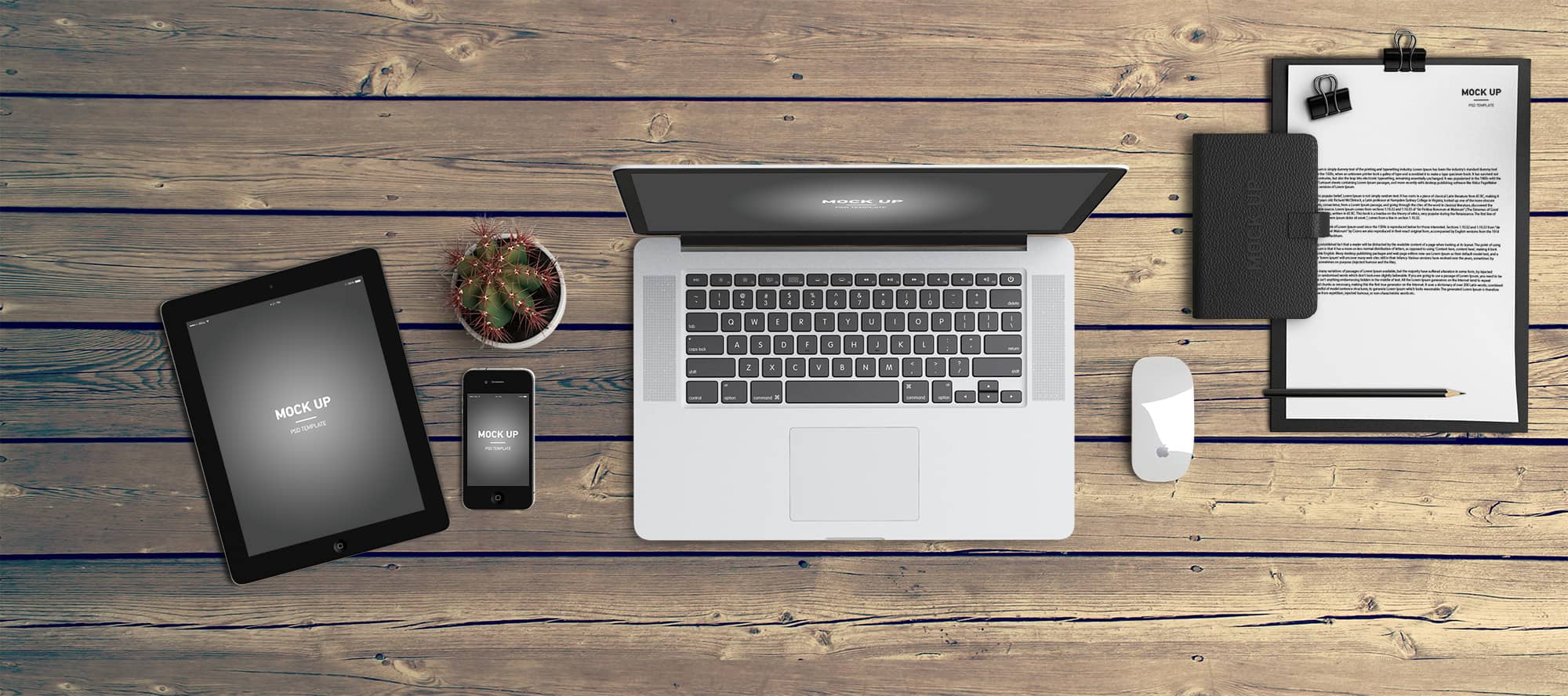 Desk with tablet, laptop, phone, and clipboard